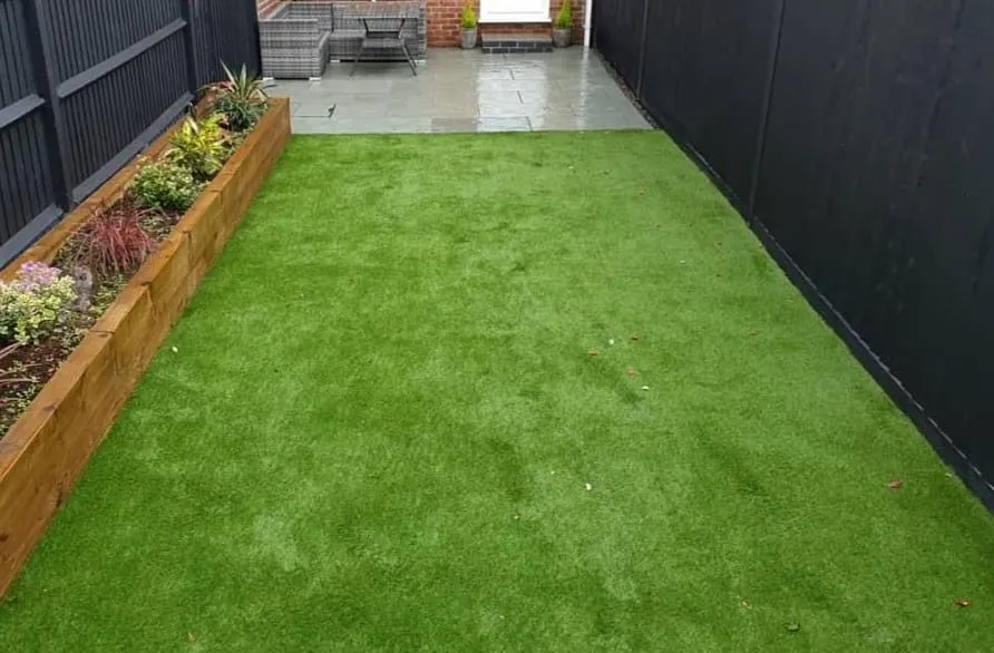 A neatly mown lawn and tidy garden after a maintenance visit